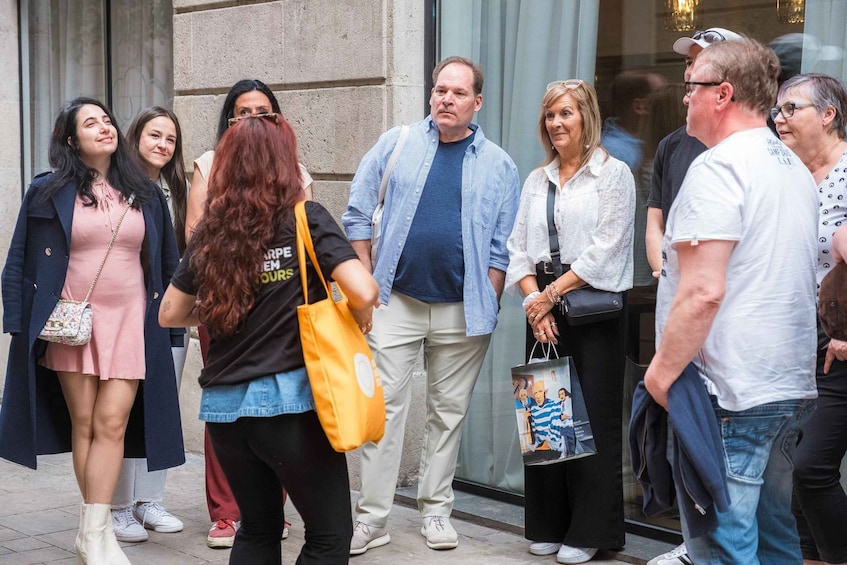 A group of people standing outside a building with a stone facade. 4