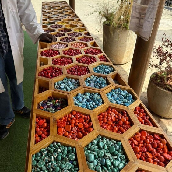 A display of colorful beads in wooden hexagonal trays. 3