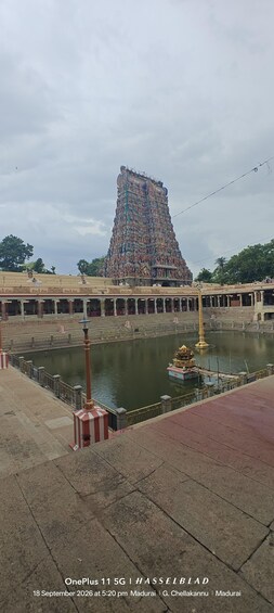 A temple with a large, ornate tower, a lotus pond, and steps leading up to the temple. 1