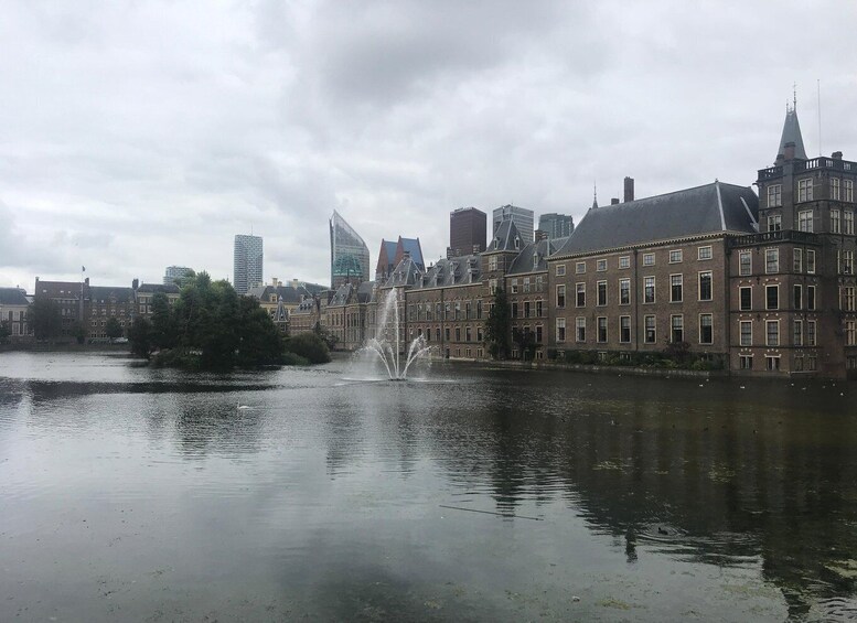 A cityscape with a river, a fountain, and historic buildings. 3