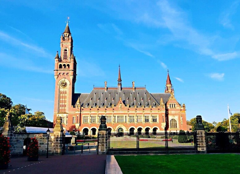 A historic building with a prominent clock tower and multiple spires. 1