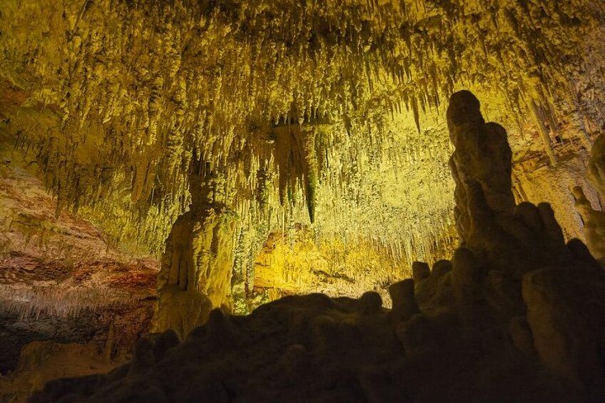 A cave interior with stalactites and stalagmites. 5