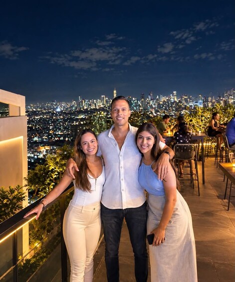 A group of people on a rooftop with a cityscape in the background. 2