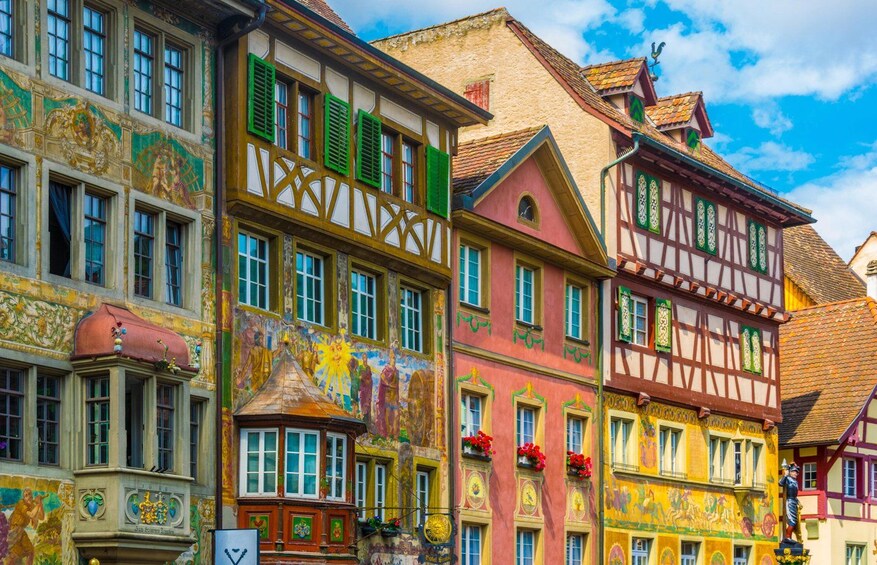 Colorful half-timbered buildings with intricate facades and a clear blue sky. 2