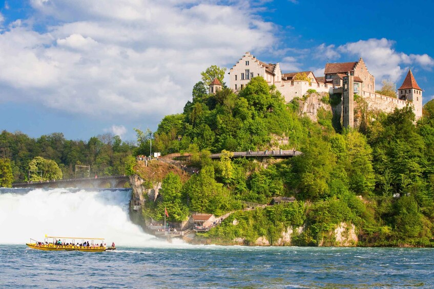 A castle on a cliff with a waterfall in the foreground. 3