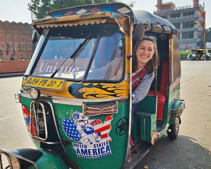 A green and yellow auto-rickshaw with 'Unique' and 'United States of America' decals. 2