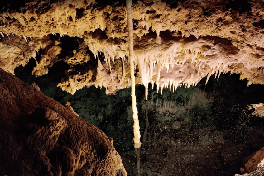 A cave interior with stalactites and stalagmites. 5