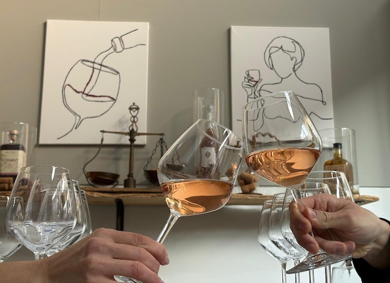 Two people toasting with wine glasses, a scale, and abstract art on the wall. 2