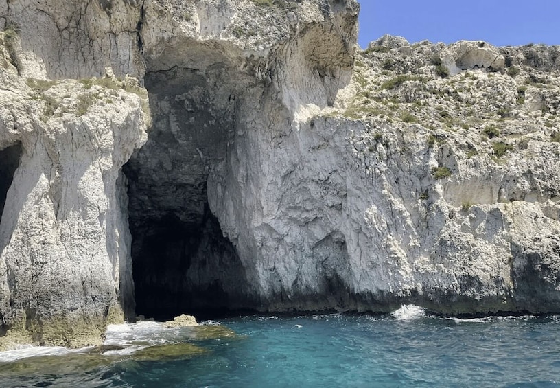 A coastal cave entrance with clear blue water. 2
