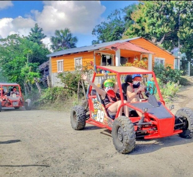 A red off-road vehicle with two people wearing helmets and a number 09 on the side. 5