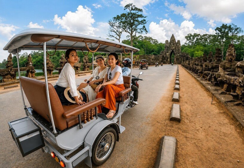 A group of people on a traditional rickshaw, a temple with stone carvings, and a clear sky. 1