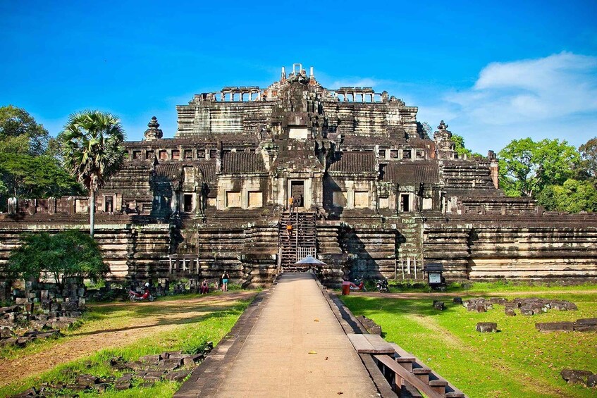 A large, ancient temple complex with a central staircase leading to a raised platform. 2