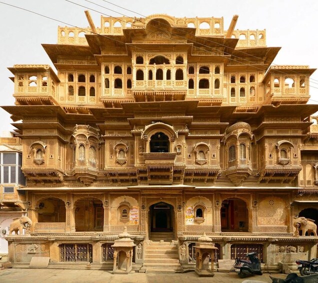 A multi-tiered, intricately carved building with balconies and statues. 4