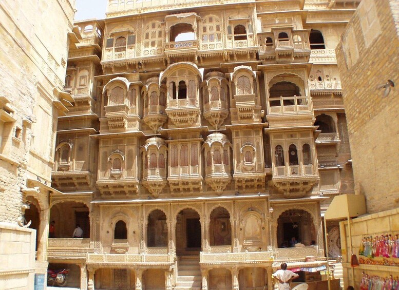 A multi-story building with ornate balconies and arched windows. 3