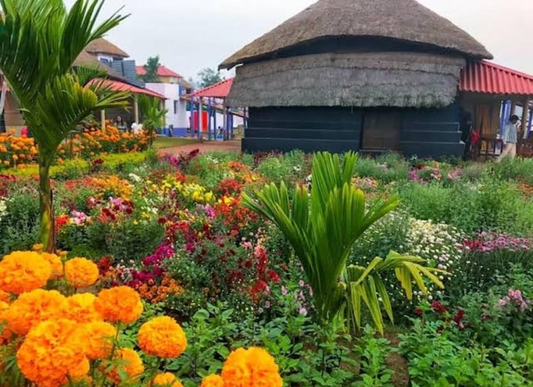 A garden with various flowers and a traditional thatched-roof structure. 2