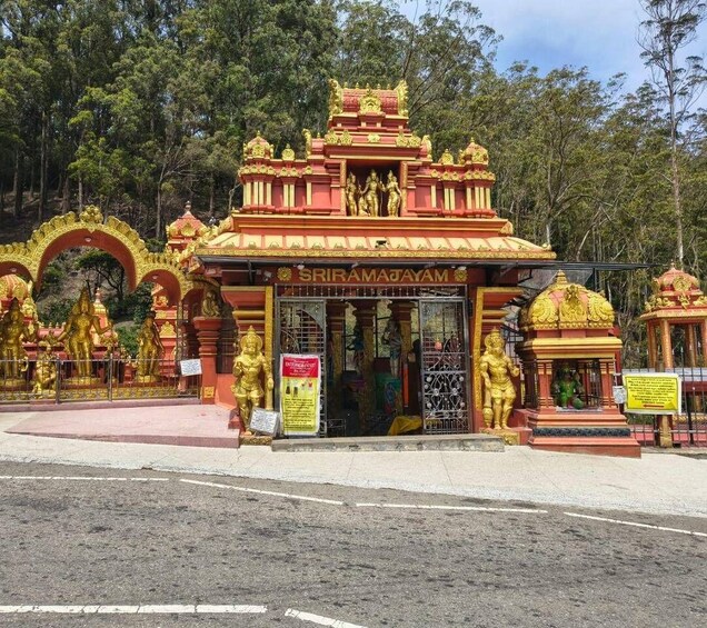 A temple entrance with golden statues and a sign reading 'SIRAMAJAYAM.' 2