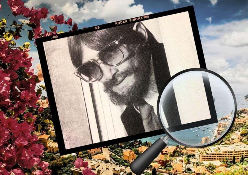 A vintage photograph of a person with glasses, a magnifying glass, and a scenic coastal town in the background. 1