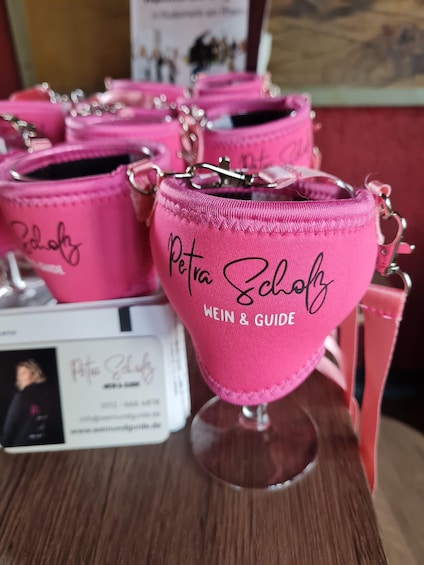 Pink bags with "Petra Scholz WEIN & GUIDE" printed on them. 1