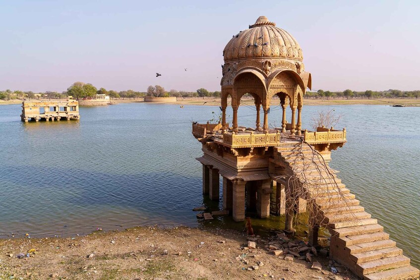 A historical structure with a dome, located by a calm river. 3