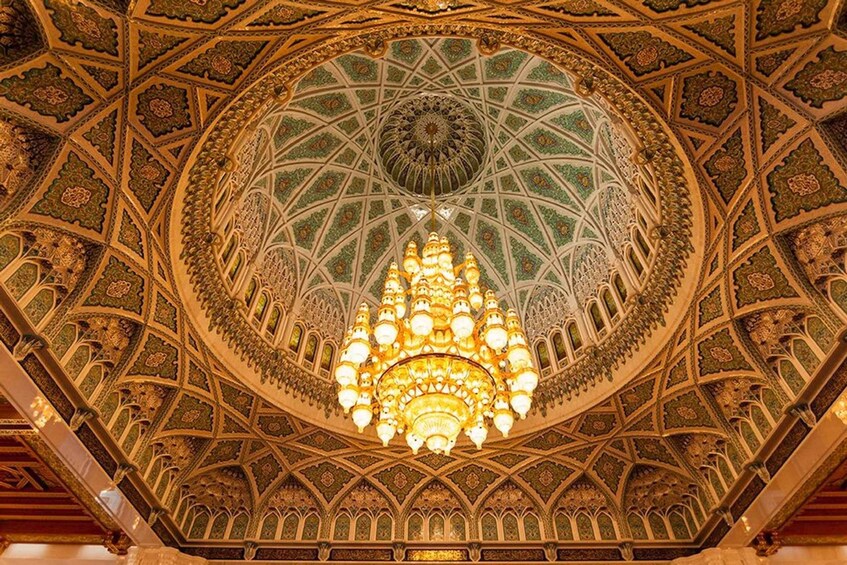 A detailed, ornate ceiling with a central chandelier. 1