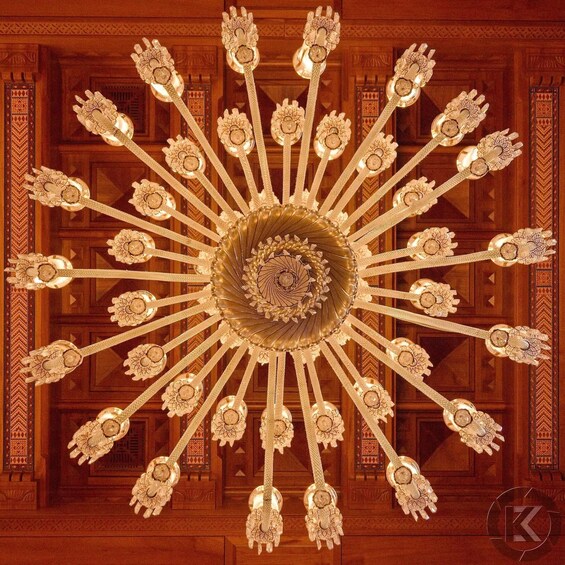 A detailed ceiling with a central circular design surrounded by symmetrical patterns. 4