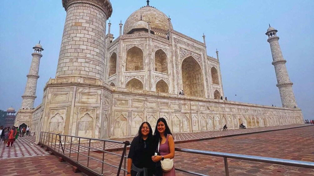 The Taj Mahal with two people standing in front. 2