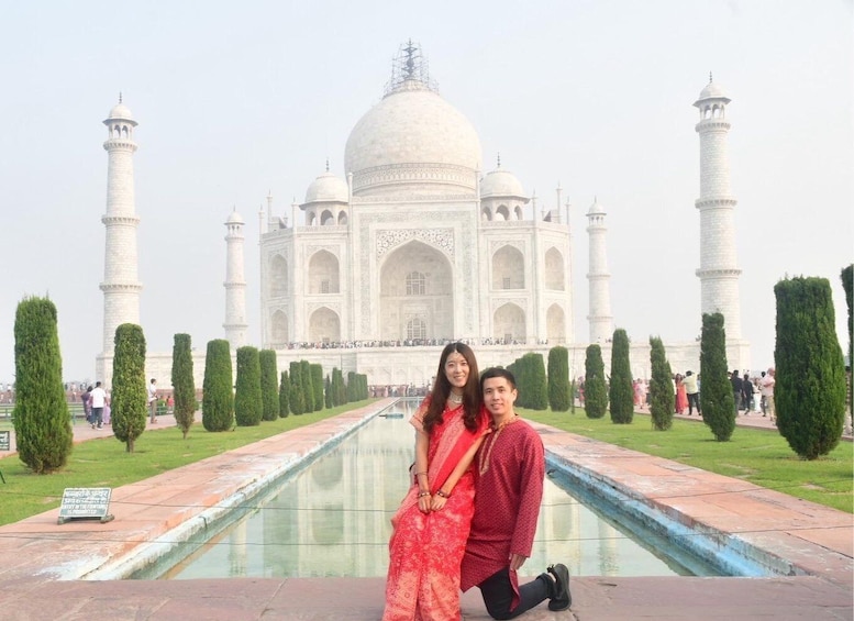 The Taj Mahal with a couple in front of it. 3
