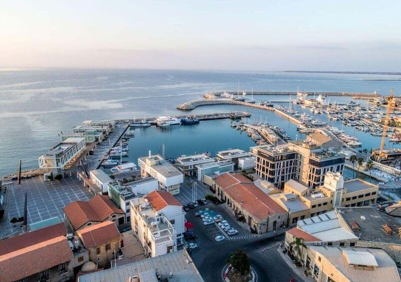 A coastal town with a marina, buildings, and a curved harbor. 5