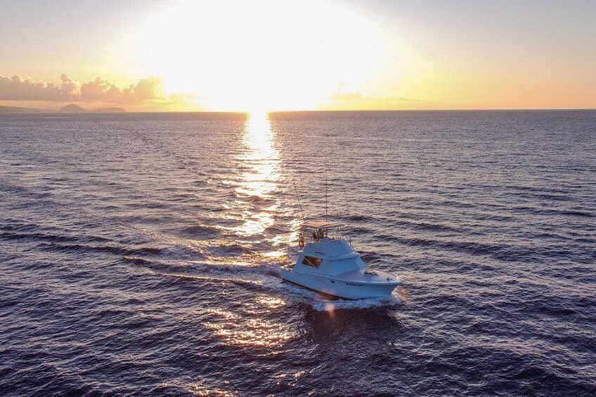 A white yacht sailing on calm ocean waters during sunset. 2