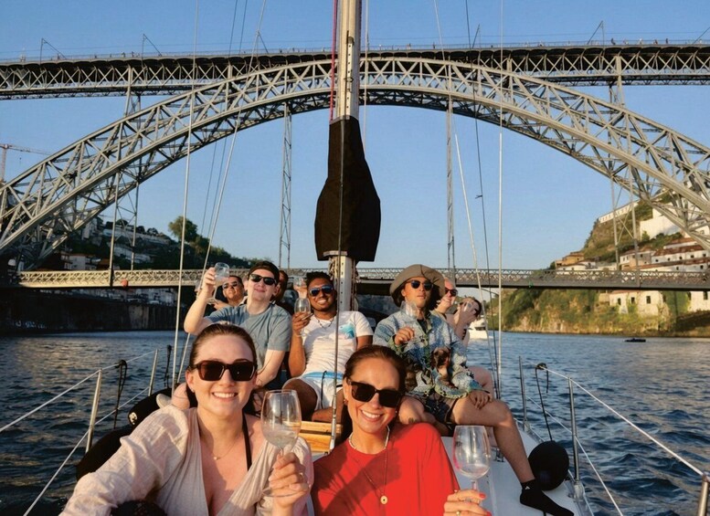 A group of people on a boat, with a bridge in the background. 5