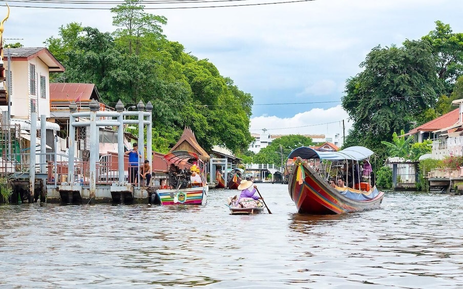 A river with boats, a bridge, and buildings along the banks. 2