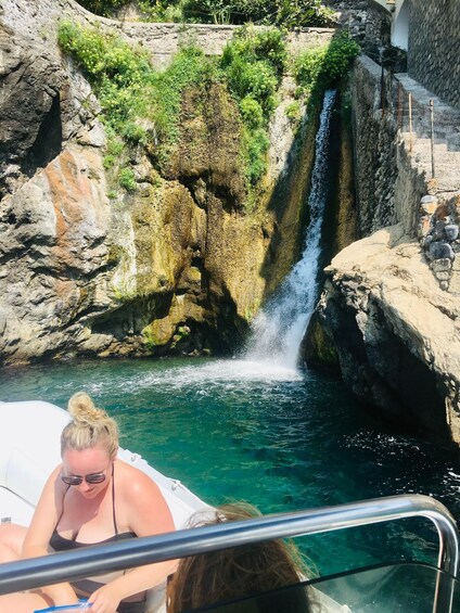 A waterfall in a rocky gorge with clear water. 3
