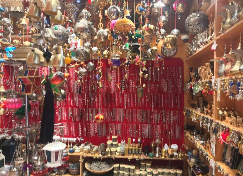 A cluttered shop with various hanging items and shelves filled with goods. 4