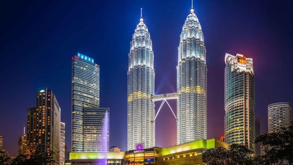 Les tours jumelles de Petronas, illuminées la nuit, se dressent au milieu d’immeubles de grande hauteur. 1