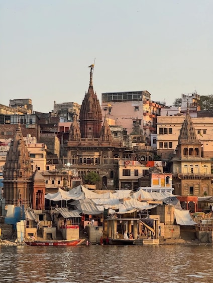 A riverside cityscape with historic temples and modern buildings. 2