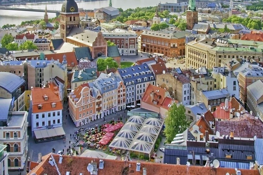 A cityscape with historic buildings, a prominent church, and a river in the background. 2
