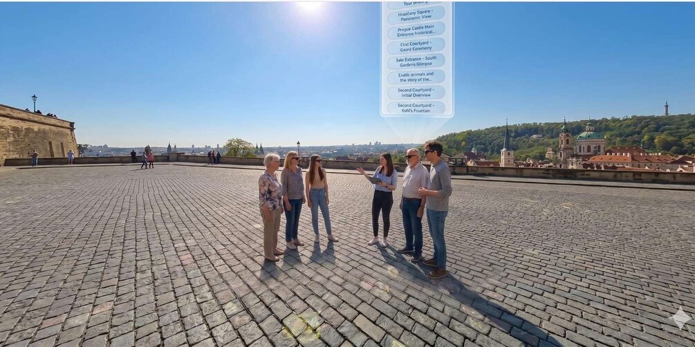 A group of people standing on a paved area with a clear view of a historic building and a church in the background. 4
