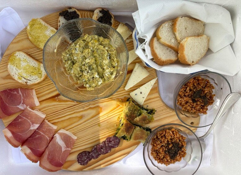 A charcuterie board with various meats, cheeses, and condiments. 5