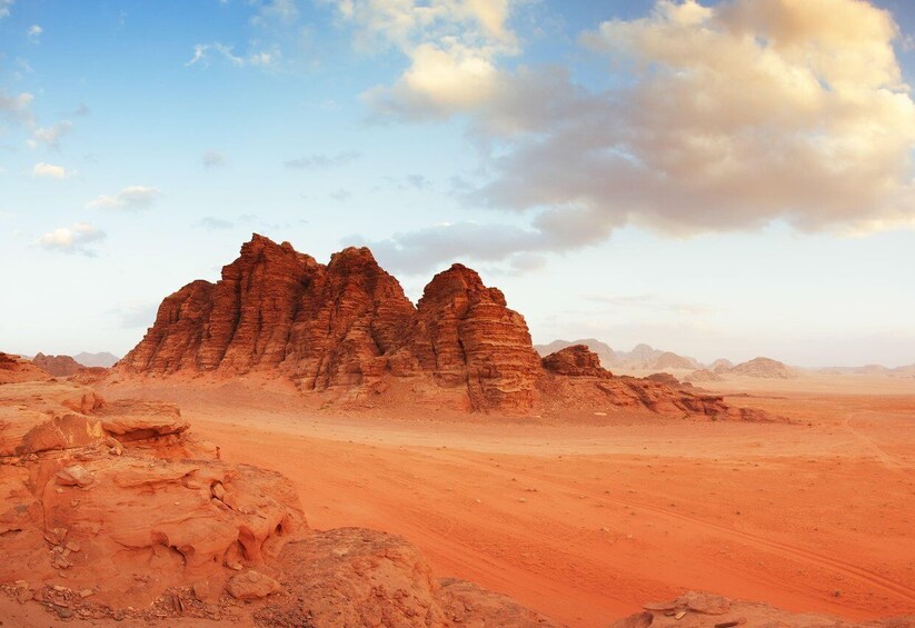A desert landscape with prominent red rock formations and a clear sky. 5