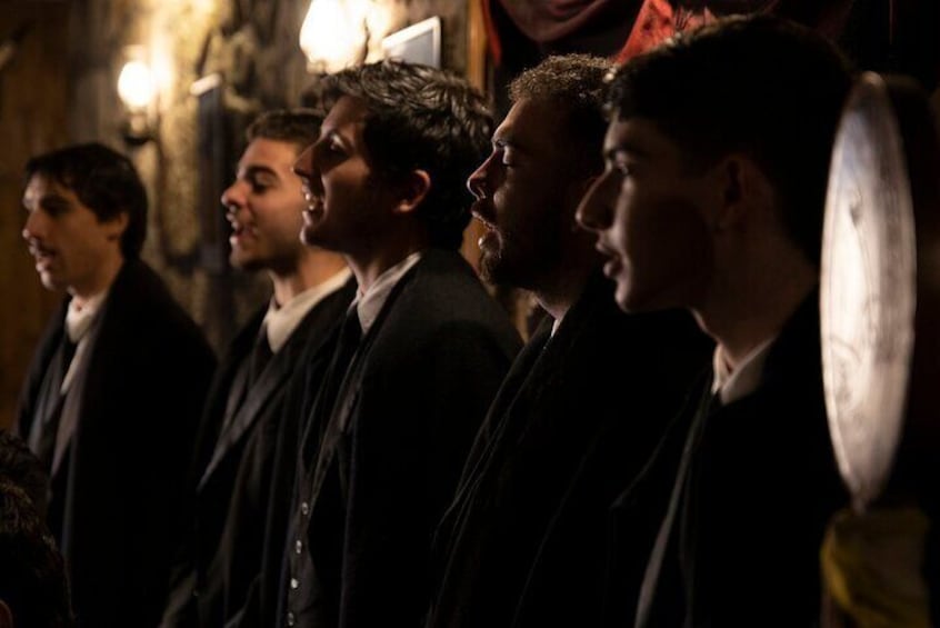 A group of people in formal attire, likely in a historical or cultural setting. 1