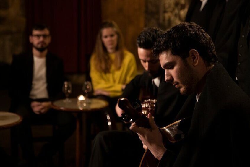A dimly lit bar with people seated at tables. 4
