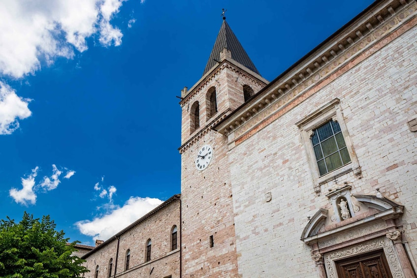A historic building with a clock tower and a clear blue sky. 2