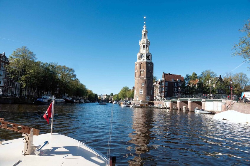 A river with a tower, a bridge, and buildings along the banks. 2