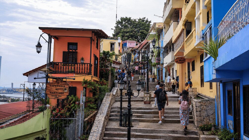 A staircase leading up to a colorful building with a sign reading 'CAFETERIA MI SANTIAGO.' 1