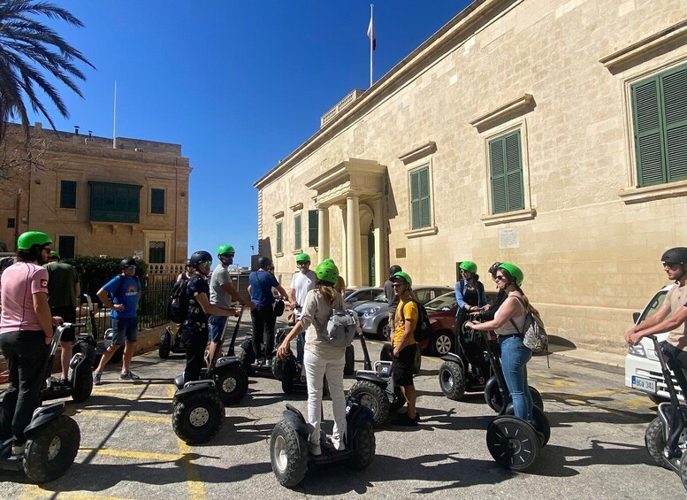 People riding Segways on a street. 5