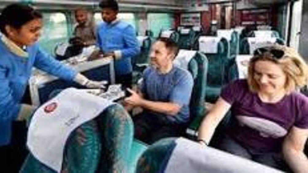 People sitting on a bus, some wearing uniforms. 3