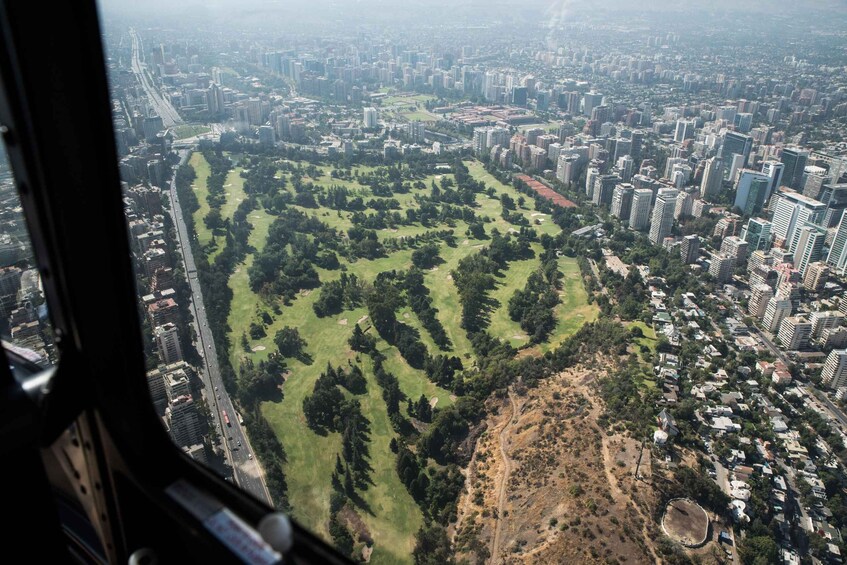 An aerial view of a city with a large park surrounded by high-rise buildings. 3