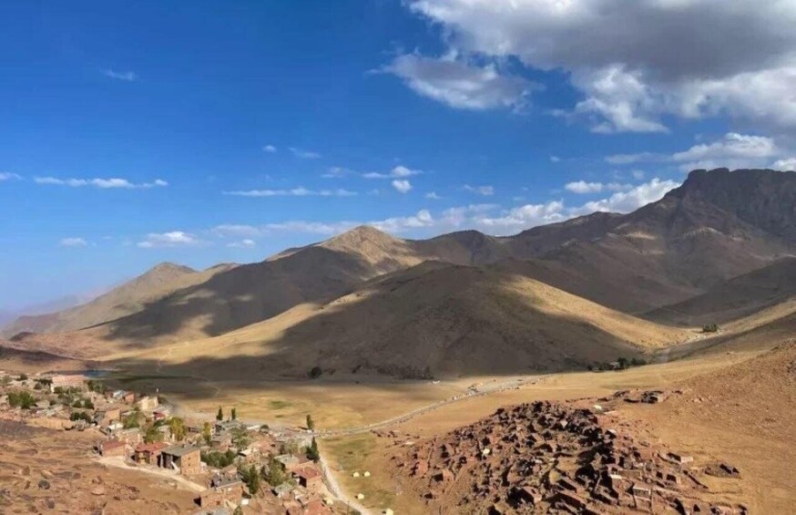 A mountainous landscape with a small village and rocky terrain. 4