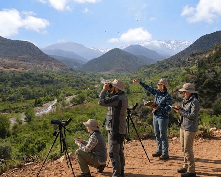 Four people observing a landscape with mountains and a river. 1