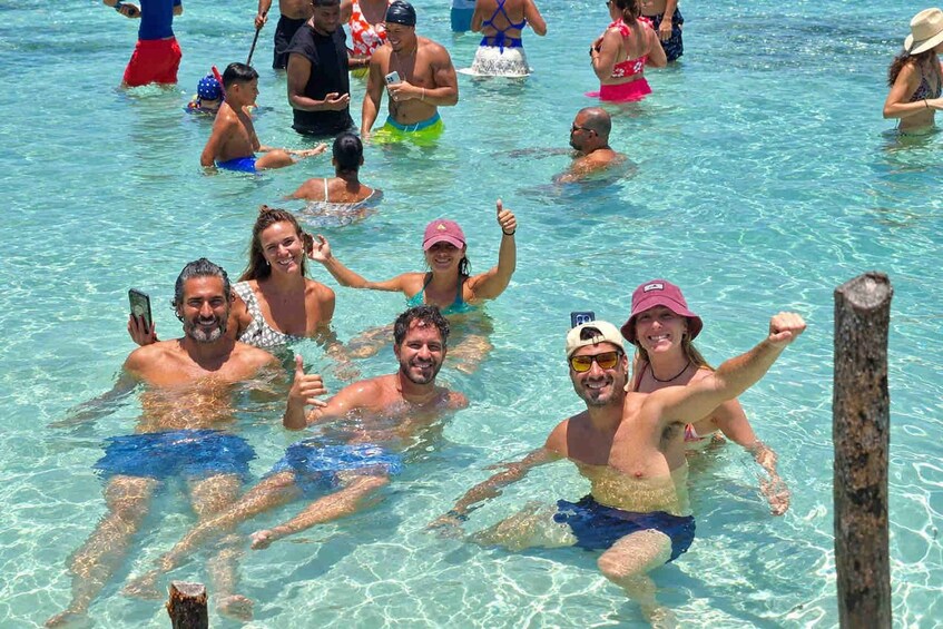 A group of people swimming in a clear blue pool. 4